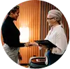 Two professional women shaking hands in a modern office setting