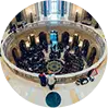 "An overhead view of a circular conference table surrounded by multiple people in a meeting or discussion."