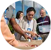 "Group of diverse professionals gathered around a table, engaging in a collaborative discussion or activity."